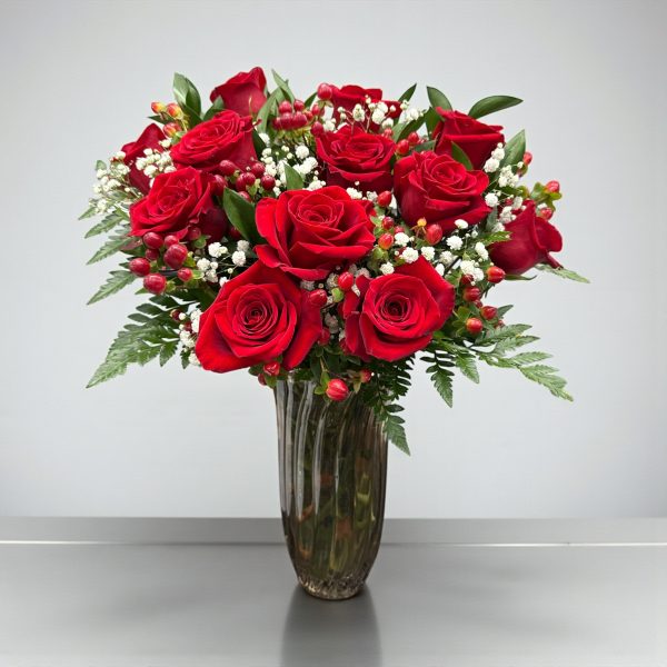 Red rose arrangement in chanterelle ribbed glass vase